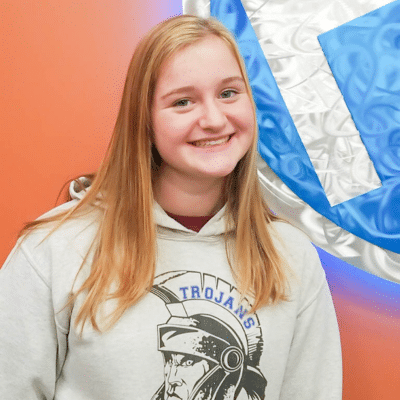 Teenage girl patient smiling and posing for a photo after treatment at holbert orthodontics, representing what to expect after getting your braces off